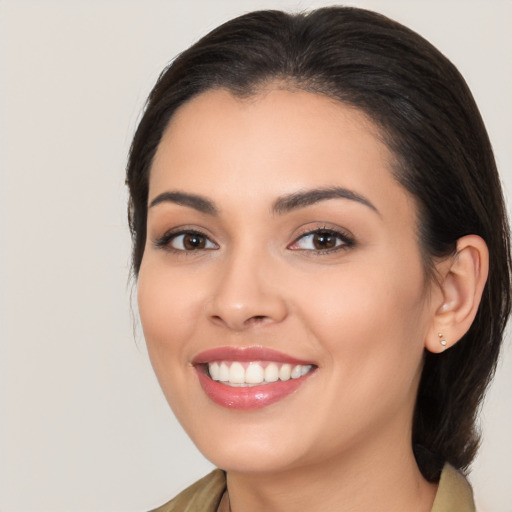 Joyful white young-adult female with long  brown hair and brown eyes