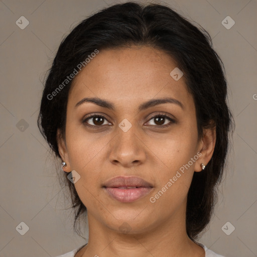 Joyful latino adult female with medium  brown hair and brown eyes