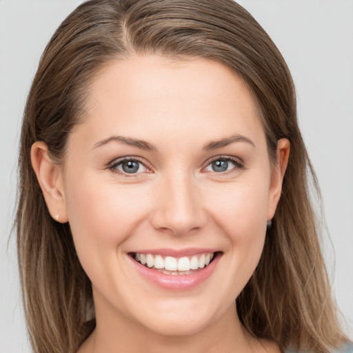 Joyful white young-adult female with long  brown hair and grey eyes