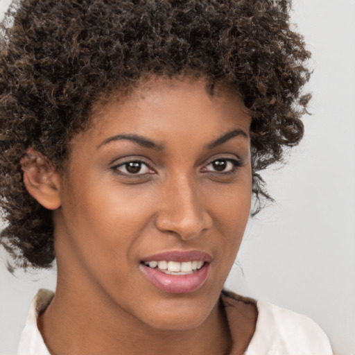 Joyful black young-adult female with medium  brown hair and brown eyes