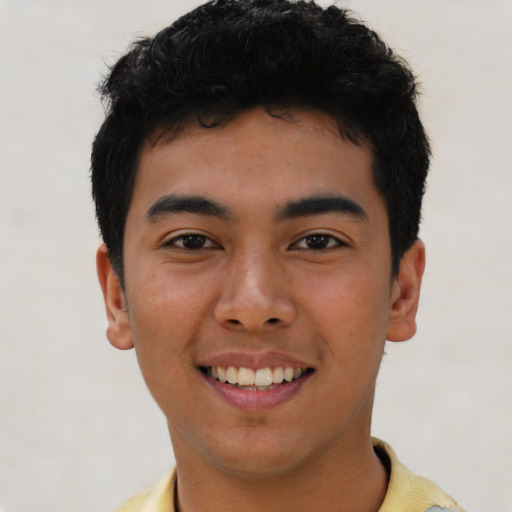 Joyful asian young-adult male with short  black hair and brown eyes