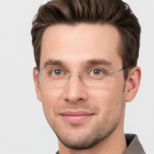 Joyful white adult male with short  brown hair and grey eyes