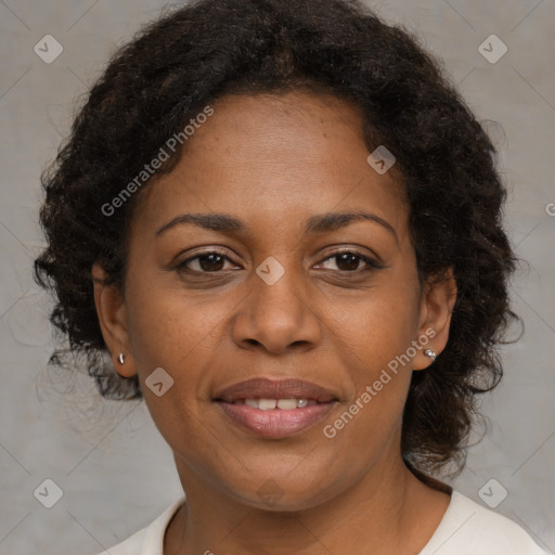 Joyful black adult female with medium  brown hair and brown eyes