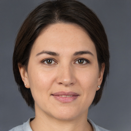 Joyful white adult female with medium  brown hair and brown eyes