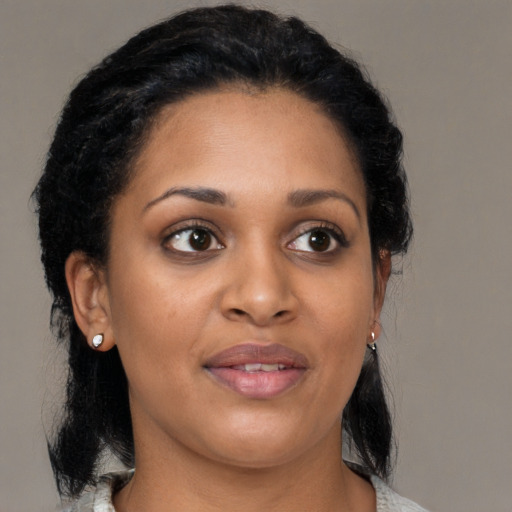 Joyful black young-adult female with medium  brown hair and brown eyes