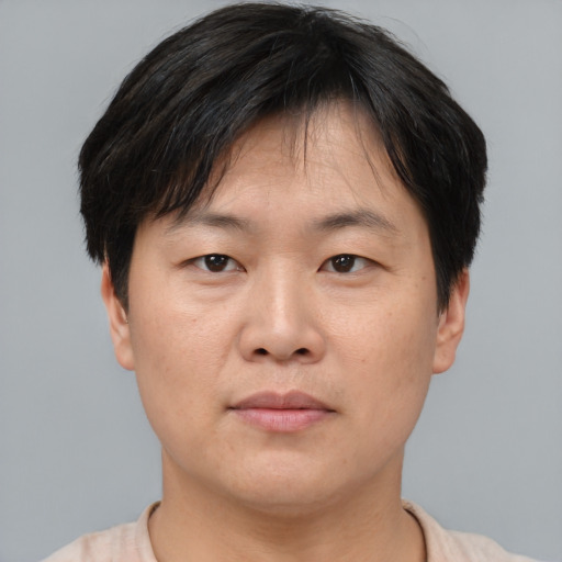 Neutral asian adult male with short  brown hair and brown eyes
