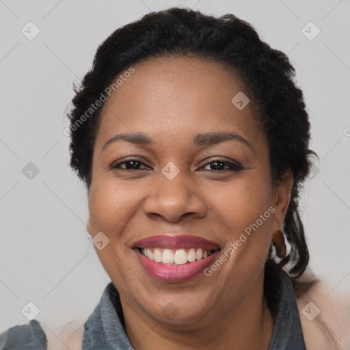 Joyful black adult female with short  brown hair and brown eyes