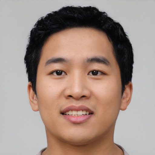 Joyful asian young-adult male with short  black hair and brown eyes