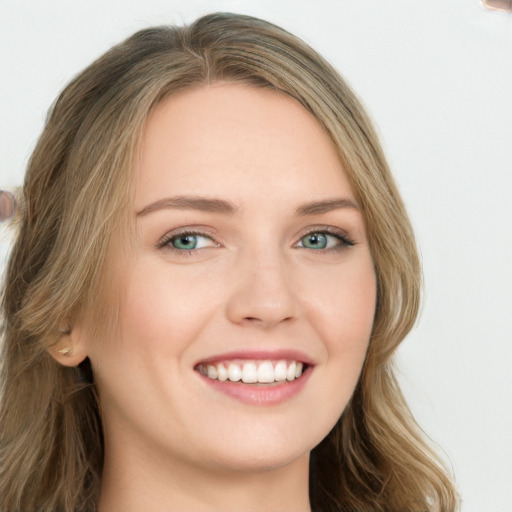 Joyful white young-adult female with long  brown hair and blue eyes