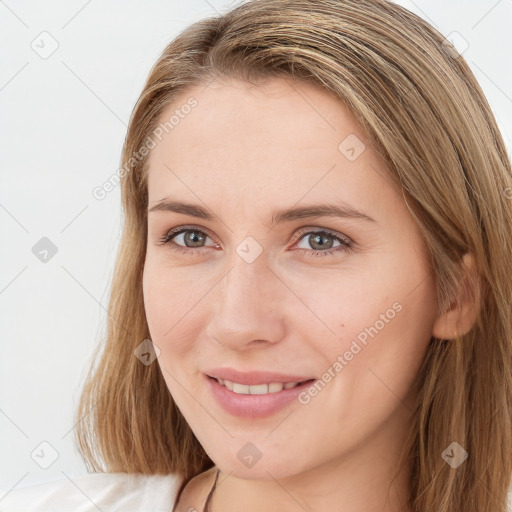 Joyful white young-adult female with long  brown hair and brown eyes