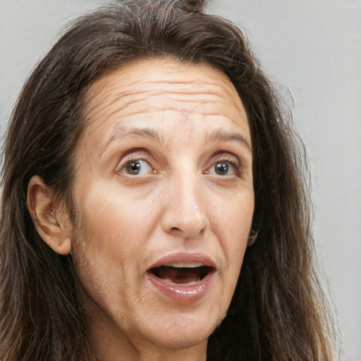 Joyful white adult female with long  brown hair and brown eyes