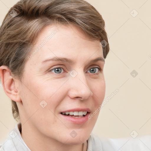 Joyful white young-adult female with short  brown hair and blue eyes