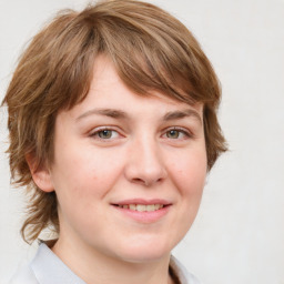 Joyful white young-adult female with medium  brown hair and blue eyes