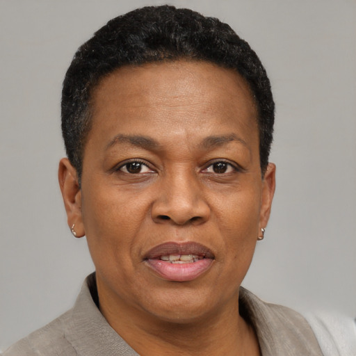Joyful black adult female with short  brown hair and brown eyes
