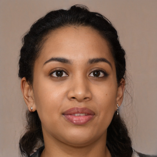 Joyful latino young-adult female with medium  brown hair and brown eyes