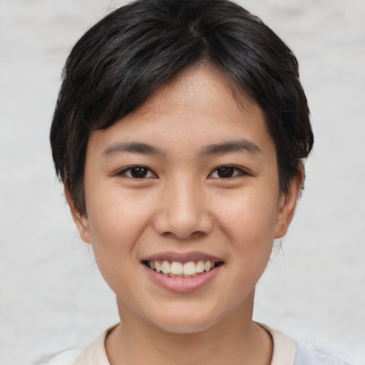 Joyful asian young-adult female with short  brown hair and brown eyes
