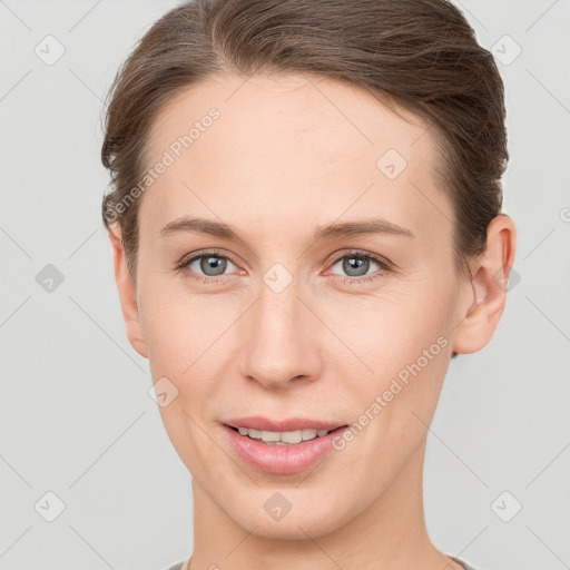 Joyful white young-adult female with short  brown hair and grey eyes