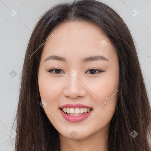 Joyful asian young-adult female with long  brown hair and brown eyes