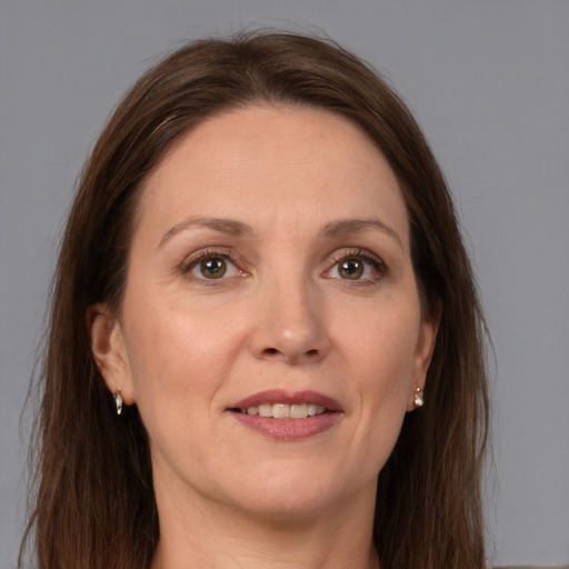 Joyful white adult female with medium  brown hair and grey eyes