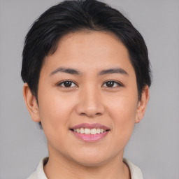 Joyful asian young-adult female with short  brown hair and brown eyes