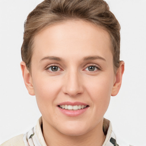 Joyful white young-adult female with short  brown hair and grey eyes