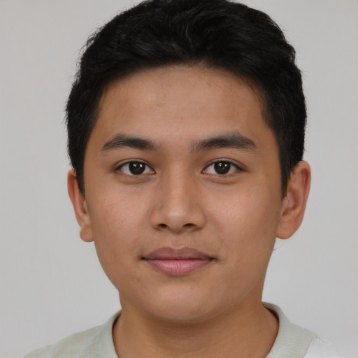 Joyful asian young-adult male with short  black hair and brown eyes