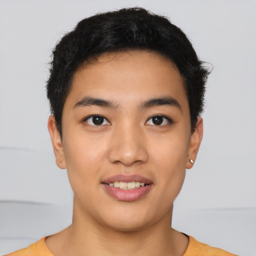 Joyful asian young-adult male with short  brown hair and brown eyes