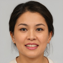 Joyful asian young-adult female with medium  brown hair and brown eyes