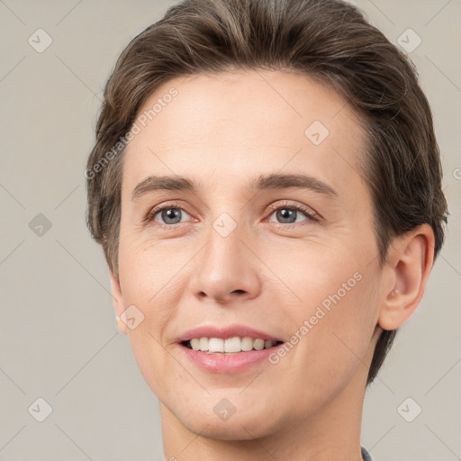 Joyful white young-adult female with short  brown hair and brown eyes