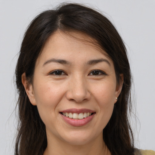 Joyful white young-adult female with medium  brown hair and brown eyes