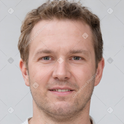 Joyful white adult male with short  brown hair and grey eyes