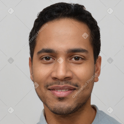 Joyful latino young-adult male with short  black hair and brown eyes