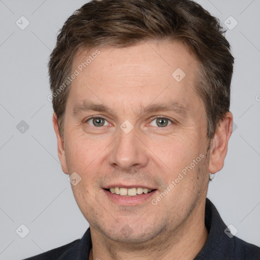 Joyful white adult male with short  brown hair and grey eyes