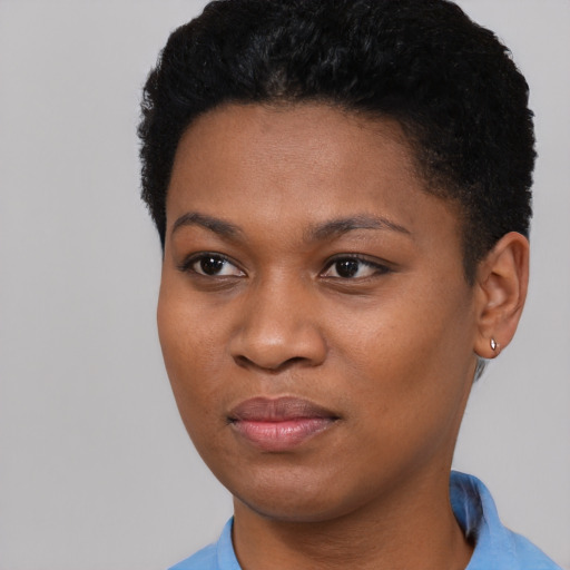Joyful black young-adult female with short  black hair and brown eyes