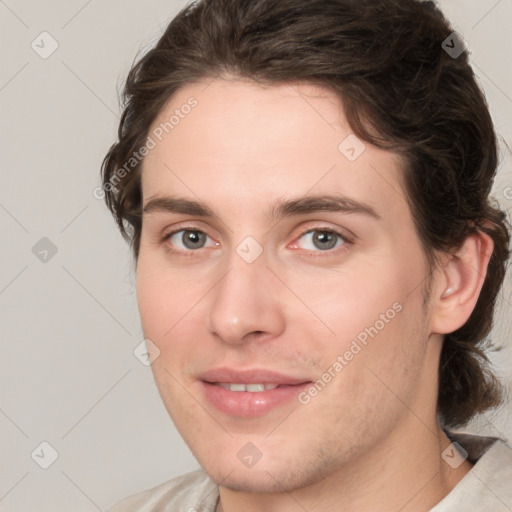 Joyful white young-adult male with medium  brown hair and brown eyes