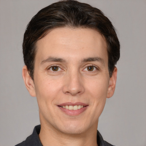 Joyful white adult male with short  brown hair and brown eyes