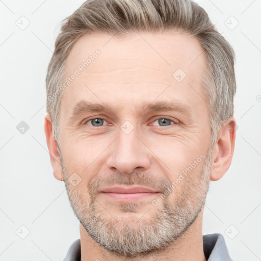 Joyful white adult male with short  brown hair and grey eyes