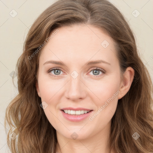 Joyful white young-adult female with long  brown hair and blue eyes