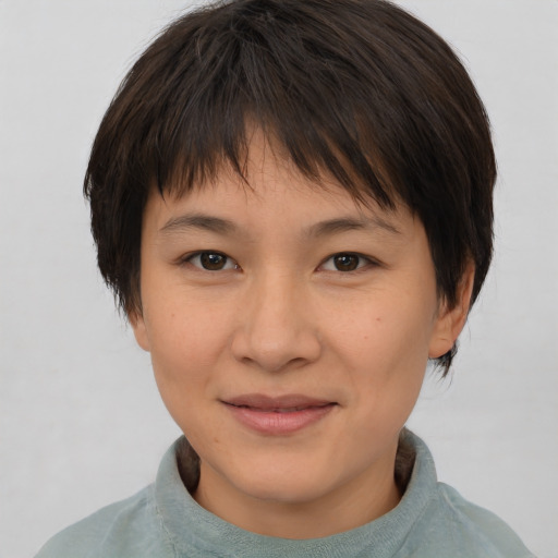 Joyful asian young-adult female with short  brown hair and brown eyes