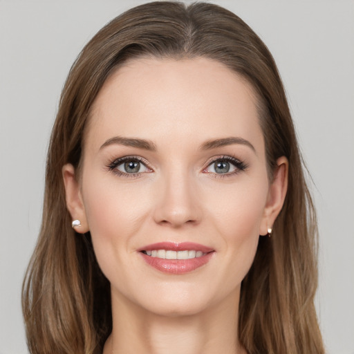 Joyful white young-adult female with long  brown hair and grey eyes