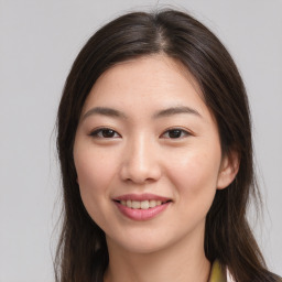 Joyful asian young-adult female with long  brown hair and brown eyes