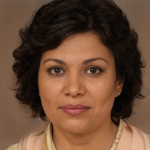 Joyful white adult female with medium  brown hair and brown eyes