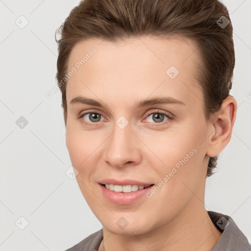 Joyful white young-adult female with short  brown hair and brown eyes