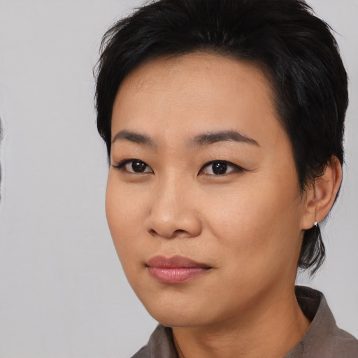 Joyful asian young-adult female with medium  black hair and brown eyes