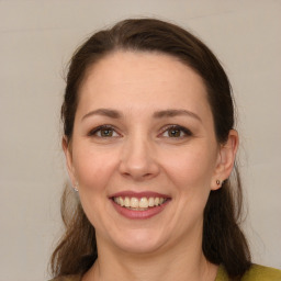 Joyful white young-adult female with medium  brown hair and brown eyes