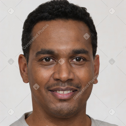Joyful black young-adult male with short  black hair and brown eyes