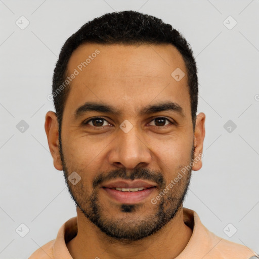 Joyful latino young-adult male with short  black hair and brown eyes