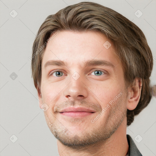 Joyful white young-adult male with short  brown hair and grey eyes