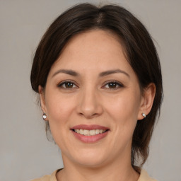 Joyful white adult female with medium  brown hair and brown eyes