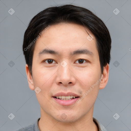 Joyful asian young-adult male with short  brown hair and brown eyes